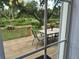 Outdoor dining area on the back deck overlooking a large backyard with mature trees at 5658 Babroff Ter, North Port, FL 34291