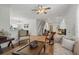 Open-concept living room seamlessly connecting the living and dining areas, enhanced by hardwood floors at 5658 Babroff Ter, North Port, FL 34291