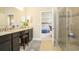 En-suite bathroom with dual vanities and glass-enclosed shower, open to bedroom at 150 Castile Ct, Punta Gorda, FL 33983