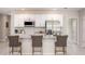 Modern kitchen featuring white cabinets, stainless steel appliances, granite countertops, and bar stool seating at 469 Chubut Ct, Punta Gorda, FL 33983