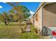 Charming home exterior featuring a stone foundation, manicured lawn and garden pots along the walkway at 6342 Saddletree Dr, Wesley Chapel, FL 33544