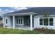 An outdoor covered patio area with plenty of windows, pillars and a brick laid floor at 5013 Sea Branch Ave, Apollo Beach, FL 33572