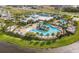 Aerial view of a community pool area with waterslides, tennis courts and playground at 5013 Sea Branch Ave, Apollo Beach, FL 33572