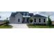 Charming single-Gathering home boasts a manicured front yard, stone paver drive, and light gray facade at 5013 Sea Branch Ave, Apollo Beach, FL 33572