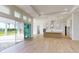 Spacious open floor plan with a modern kitchen and sliding glass doors leading to the patio at 5013 Sea Branch Ave, Apollo Beach, FL 33572