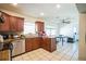 A kitchen that features wood cabinetry, stainless steel appliances, tile flooring, and lots of counter space at 2210 Wallwood Pl, Brandon, FL 33510