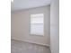 Bedroom with window, neutral carpet and white walls at 25880 Prada Dr, Punta Gorda, FL 33955