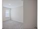 Cozy bedroom with plush carpeting and a window offering natural light at 25880 Prada Dr, Punta Gorda, FL 33955
