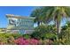 Community sign with flowers and plants in front of it at 25880 Prada Dr, Punta Gorda, FL 33955