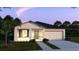 Charming single-story home featuring a two-car garage and well-maintained landscaping at 25880 Prada Dr, Punta Gorda, FL 33955
