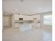 Bright kitchen features stainless appliances, granite counters, and a center island at 25880 Prada Dr, Punta Gorda, FL 33955