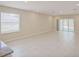 Spacious living room with tile flooring, a window, and sliding glass door access to the backyard at 25880 Prada Dr, Punta Gorda, FL 33955