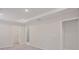 Spacious main bedroom featuring tray ceilings, plush carpeting and ensuite bathroom at 25880 Prada Dr, Punta Gorda, FL 33955