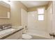 Bright bathroom features a tub and shower combination with tiled walls and granite topped vanity at 3201 Cord St, Tampa, FL 33605