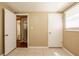 This bedroom features neutral walls, tile flooring, and a window with blinds for natural light at 3201 Cord St, Tampa, FL 33605