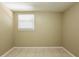 A neutral bedroom featuring tile flooring and natural lighting at 3201 Cord St, Tampa, FL 33605