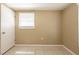 This bedroom features neutral walls, tile flooring, and a window with blinds for natural light at 3201 Cord St, Tampa, FL 33605