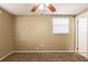 Empty carpeted bedroom with tan walls, a window, and a ceiling fan at 3201 Cord St, Tampa, FL 33605