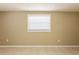 A neutral bedroom featuring tile flooring and natural lighting at 3201 Cord St, Tampa, FL 33605