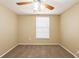 A carpeted empty bedroom with tan walls and a ceiling fan at 3201 Cord St, Tampa, FL 33605