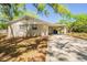 View of the rear of the house showing brick facade and covered parking on a large lot at 3201 Cord St, Tampa, FL 33605