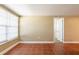 An empty bonus room features tan walls and tile floors, and a large window for natural light at 3201 Cord St, Tampa, FL 33605