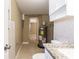 A utility room featuring neutral tiling, storage cabinets, and an updated water heater at 3201 Cord St, Tampa, FL 33605