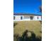 Home's backyard features a well-maintained lawn and sliding glass doors at 17065 Malta Ave Ave, Port Charlotte, FL 33954