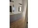 Bathroom featuring double sinks, modern cabinetry, and wood-look flooring at 17065 Malta Ave Ave, Port Charlotte, FL 33954