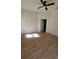 Bright, empty bedroom with wood-look flooring and ceiling fan at 17065 Malta Ave Ave, Port Charlotte, FL 33954