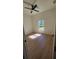 Bright bedroom featuring hardwood flooring, a ceiling fan, and natural light from the window at 17065 Malta Ave Ave, Port Charlotte, FL 33954