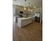 Stylish kitchen featuring modern cabinetry, an island, stainless appliances, and hardwood floors at 17065 Malta Ave Ave, Port Charlotte, FL 33954