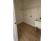 Functional laundry room featuring a utility sink, shelving, and hardwood floors at 17065 Malta Ave Ave, Port Charlotte, FL 33954
