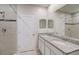 Bathroom features dual sinks, granite counters, and modern tiled walls providing a clean and functional space at 2258 Sulstone Dr, Punta Gorda, FL 33983