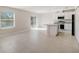 Open concept kitchen with granite island, stainless appliances, and sliding glass door at 2258 Sulstone Dr, Punta Gorda, FL 33983