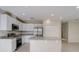 Well-lit kitchen features an island, stainless steel appliances, and ample cabinet space at 2258 Sulstone Dr, Punta Gorda, FL 33983