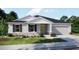 Charming single-story home with a stone facade, well-manicured lawn, and a two-car garage at 2349 Broadpoint Dr, Punta Gorda, FL 33983