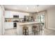 Modern kitchen featuring white cabinets, stainless steel appliances, granite countertops, and a central island with barstool seating at 2349 Broadpoint Dr, Punta Gorda, FL 33983