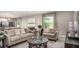 Open living space with comfortable seating, neutral decor, and a view into the kitchen and dining area at 2349 Broadpoint Dr, Punta Gorda, FL 33983