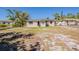 The backyard showcases a modest lawn and mature trees surrounding a single-story home at 2500 Erie S St, St Petersburg, FL 33712