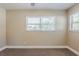 A view of bedroom with large windows, neutral paint, and carpeted floors at 2500 Erie S St, St Petersburg, FL 33712