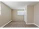 Cozy bedroom features neutral carpet, painted brick accent wall, and a window with white blinds for natural light at 2500 Erie S St, St Petersburg, FL 33712