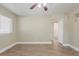 Neutral living room featuring hardwood flooring, bright windows and a ceiling fan at 2500 Erie S St, St Petersburg, FL 33712