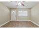 Neutrally decorated living room with wood-look flooring, a ceiling fan, and ample natural light at 2500 Erie S St, St Petersburg, FL 33712