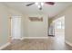 Open-concept living room with neutral walls, wood-look floors, and a ceiling fan at 2500 Erie S St, St Petersburg, FL 33712