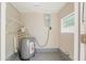 Compact utility room features a water heater, wire shelving, and basic fixtures for essential home maintenance at 2500 Erie S St, St Petersburg, FL 33712
