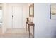 Entryway with decorative table, mirror, and tiled floor at 25575 Calusa Dr, Punta Gorda, FL 33955