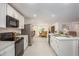 Modern kitchen featuring white cabinets, stainless steel appliances, and an open layout at 25575 Calusa Dr, Punta Gorda, FL 33955
