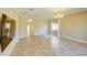 Spacious living room with tile flooring, neutral walls, and a modern chandelier at 27452 Amelia Isle Ct, Wesley Chapel, FL 33544