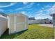 A storage shed offers space for tools and equipment in the fenced backyard of this home at 27452 Amelia Isle Ct, Wesley Chapel, FL 33544